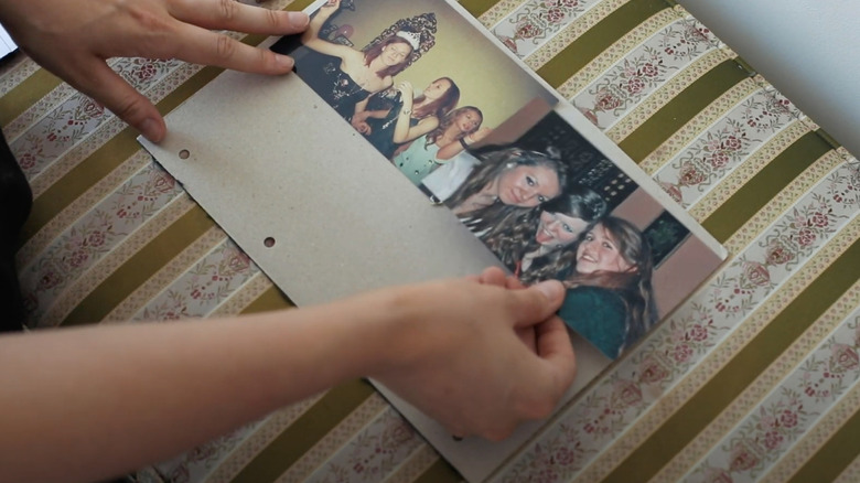 Woman placing photos on cardboard