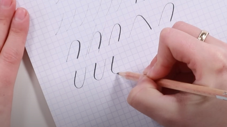 Woman trying out calligraphy technique