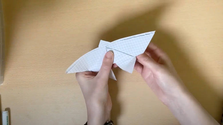 Woman folding paper into origami