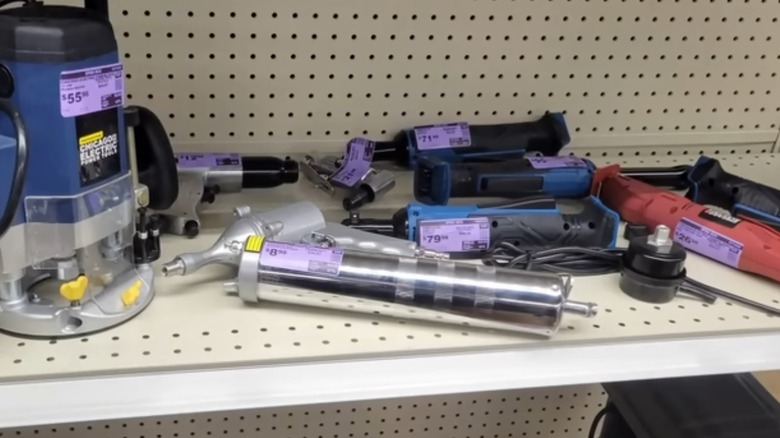 Open box items with purple price tags on a shelf at Harbor Freight.