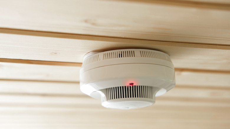 A smoke alarm on a ceiling