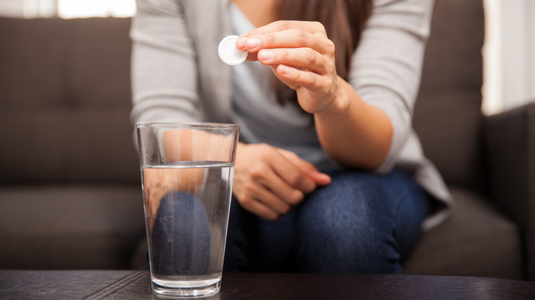 A lady popping some pills 