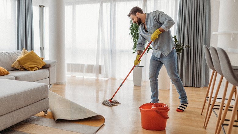 A man cleaning the floor 