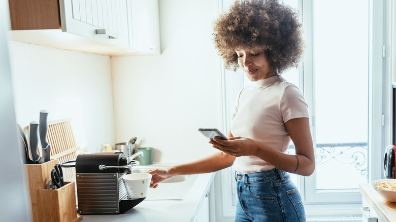 A lady making coffee 