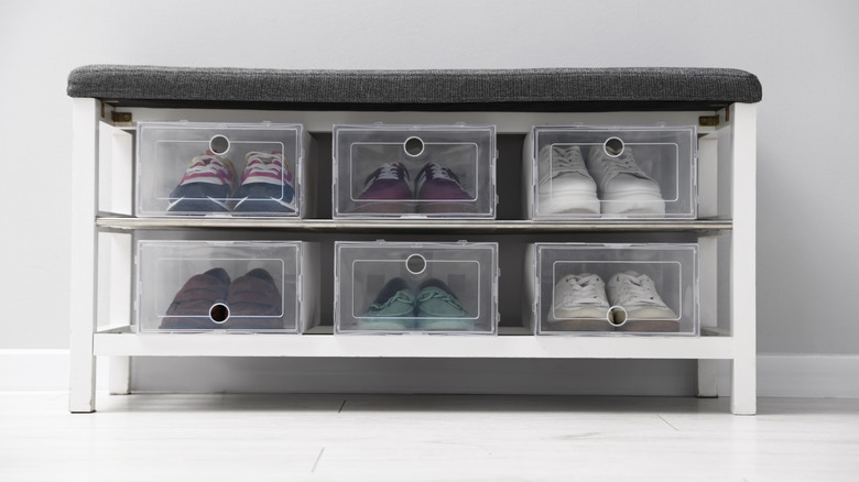 A modern shoe storage bench with clear shoe storage containers