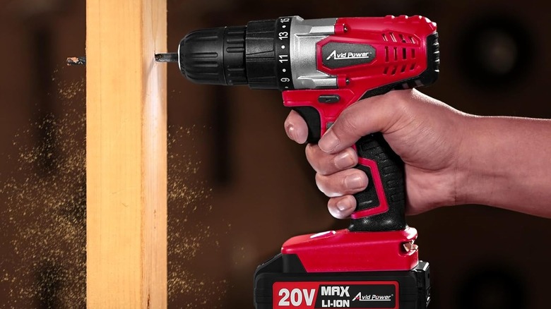 A person drilling wood with Avid Power's 20V Cordless Drill