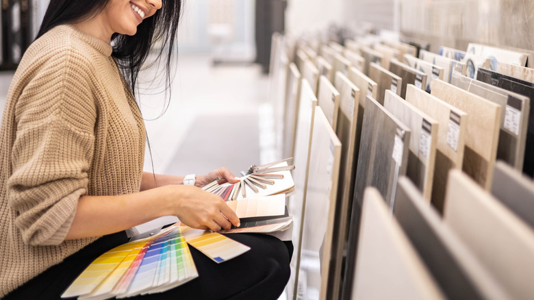 A woman looking through tile samples