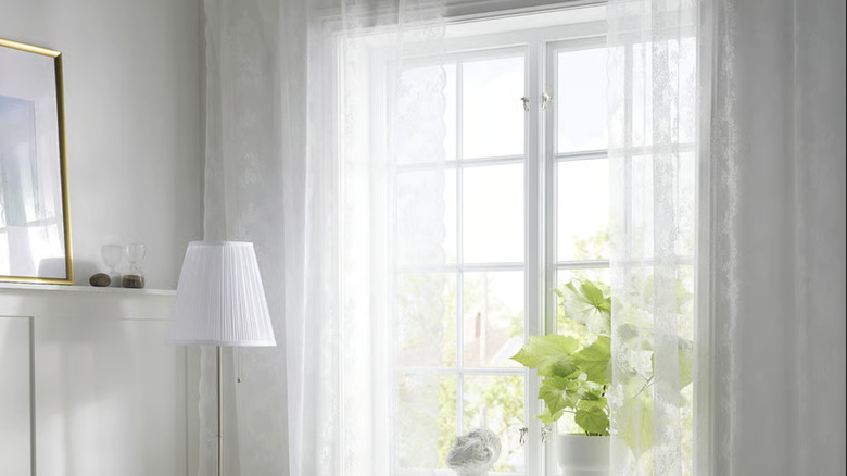 A pair of ALVINE SPETS sheer curtains from IKEA hanging in a living room