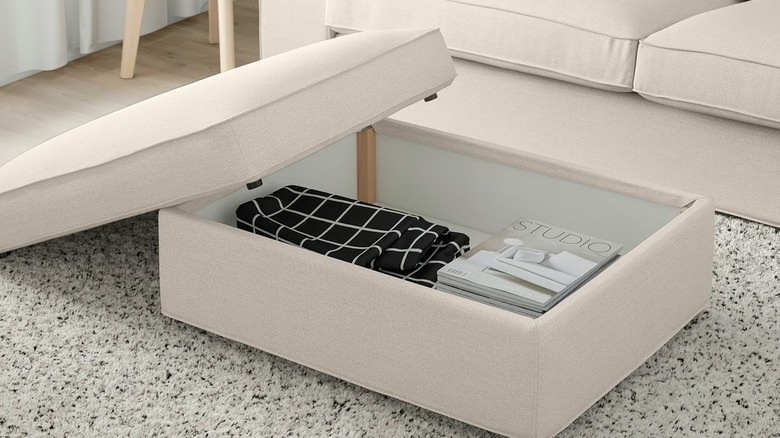Open KIVIK Ottoman with storage with magazines and blankets inside