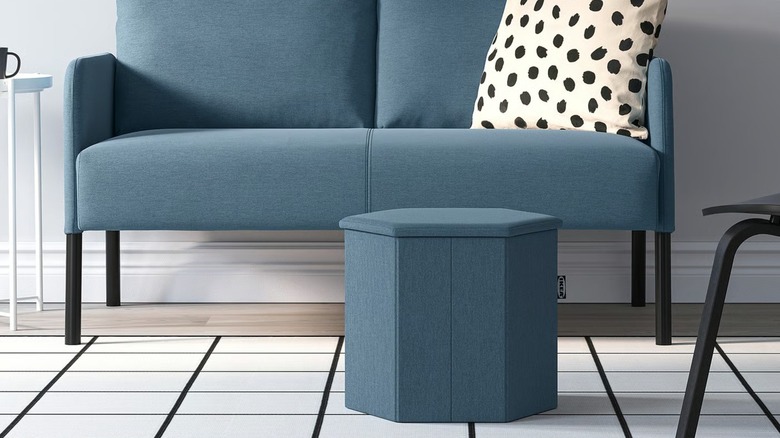 blue KJUGE Ottoman in front of blue love seat