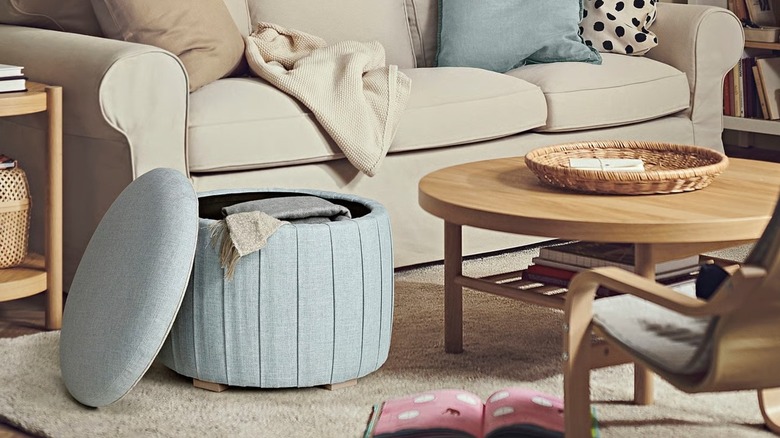 Open ÅTERLÖGA storage pouffe in living room