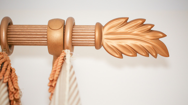 Carved wooden finial on curtain rod