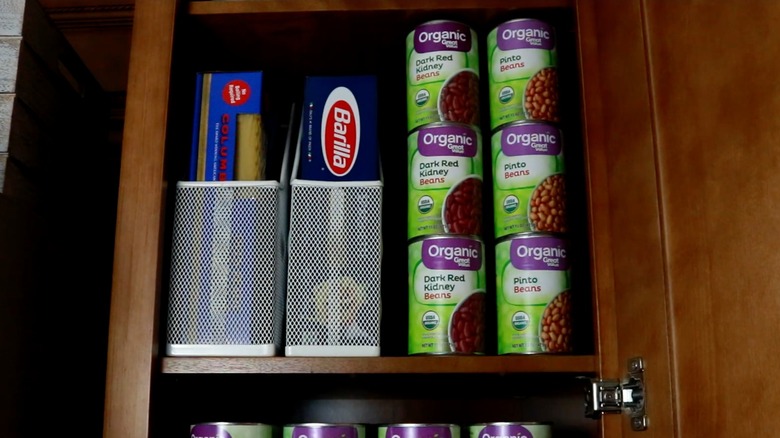 Magazine holders organizing pasta in pantry