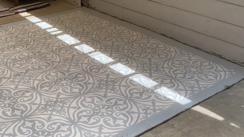 Person painting a porch