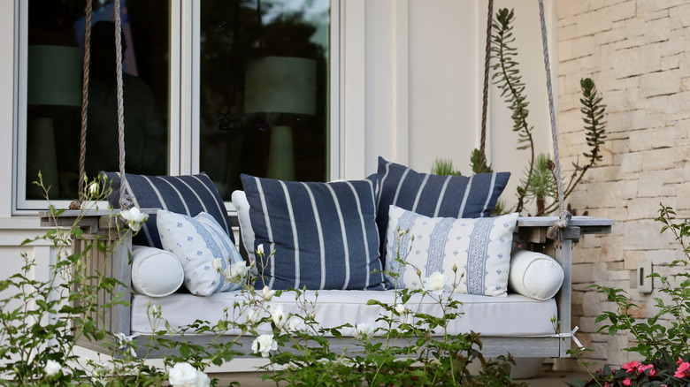 Porch swing with pillows on it