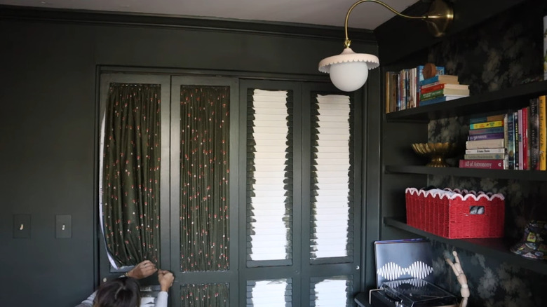 person installing gathered fabric to conceal louvers on bifold closet doors