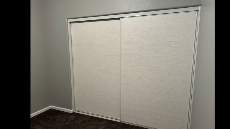 mirrored closet doors covered with wallpaper for a more modern look