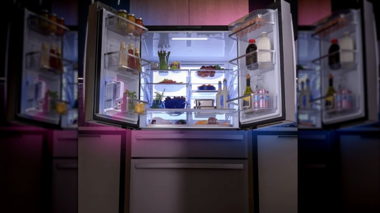 GE Profile fridge with LED lights and doors open showing ample shelving space