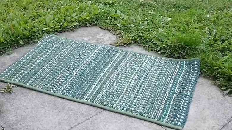 Outdoor weaved rag rug on a patio deck