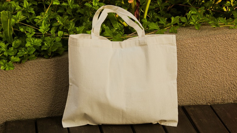 Off white tote bag in a garden