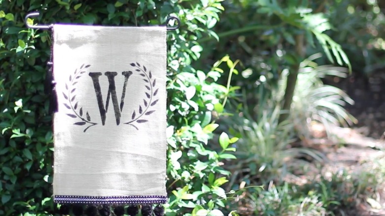 Garden flag made with white fabric and a large W letter on it
