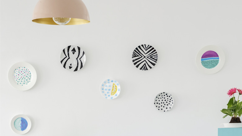 A white wall full of decorative plates
