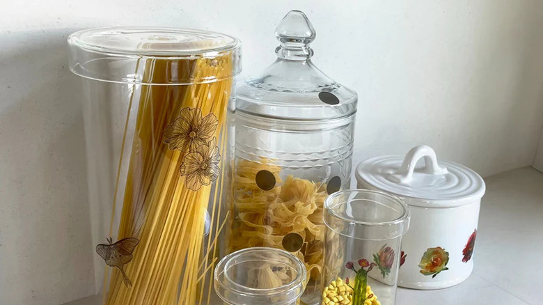 Kitchen canisters with flower decals full of pasta and beans