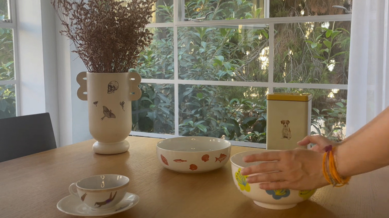 A set of dinnerware on a table with decor tattoos