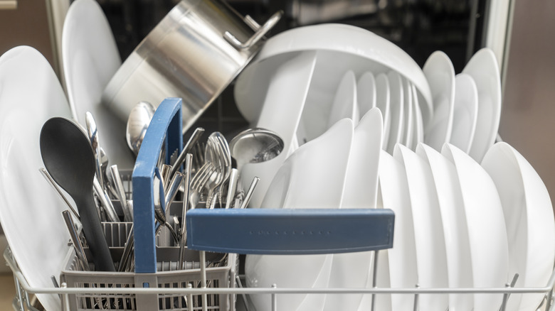 A dishwasher overloaded with dishes