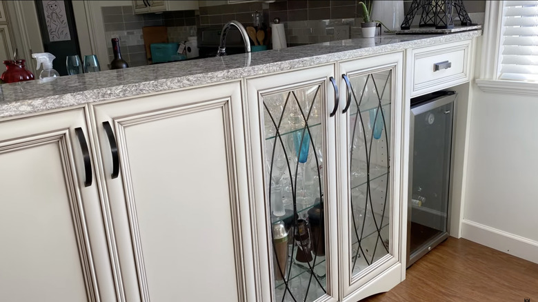 A kitchen peninsula with outward-facing drawers and a fridge, making the most of a corner by the kitchen wall
