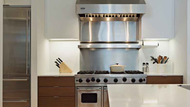 A large oven and ventilation hood in a home kitchen