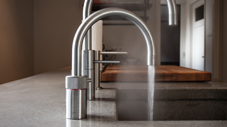 A dedicated boiling water tap, with a larger, regular faucet in the background