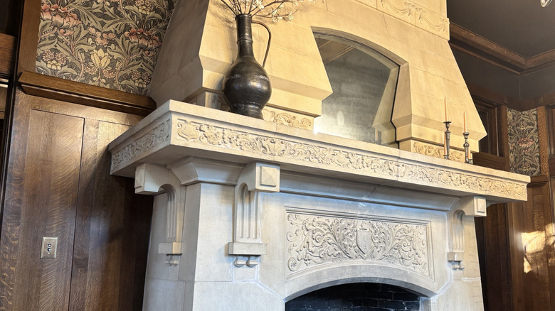 White stone fireplace with detailed carvings