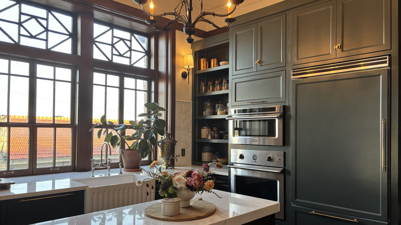 Kitchen with blue-gray cupboards and fridge