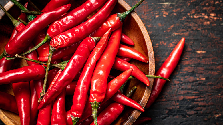 Wooden plate filled with fresh hot peppers