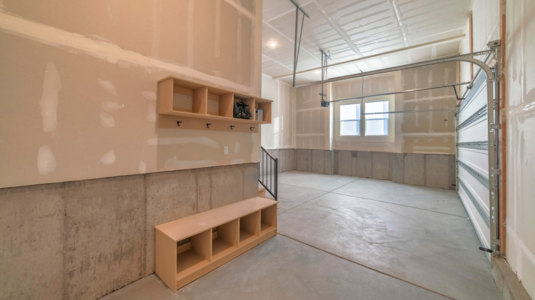 Mudroom area with a bench and storage inside of a garage