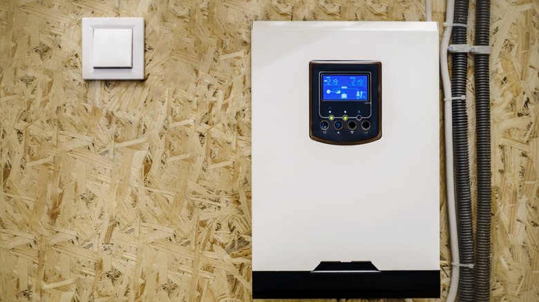 Solar power inverter mounted on a wood wall