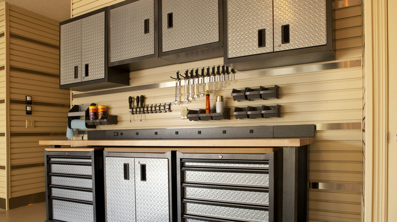 Work bench station with mounted tools in garage