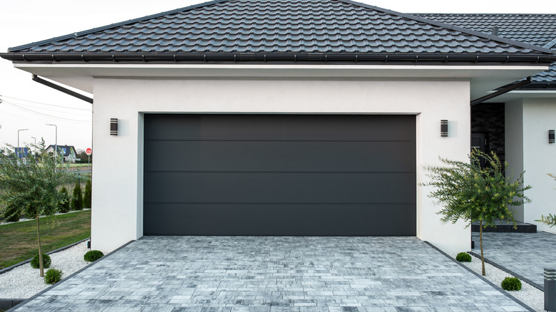 Modern white garage exterior with black garage door