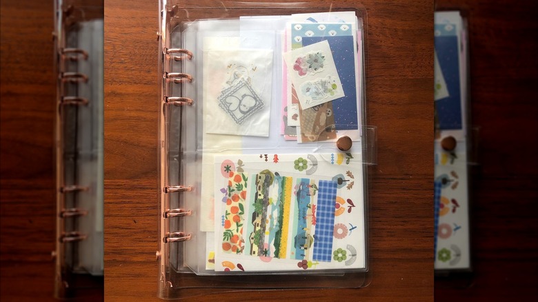 rose gold binder ring holding pouches filled with crafting items