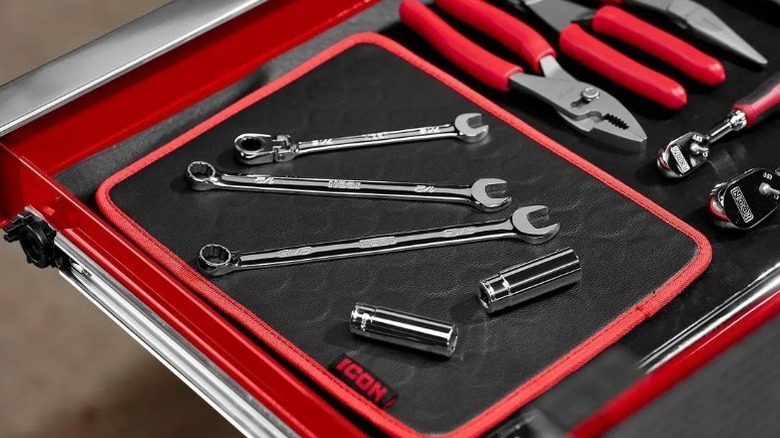 closeup on magnetic tool mat with wrenches and rounded tools