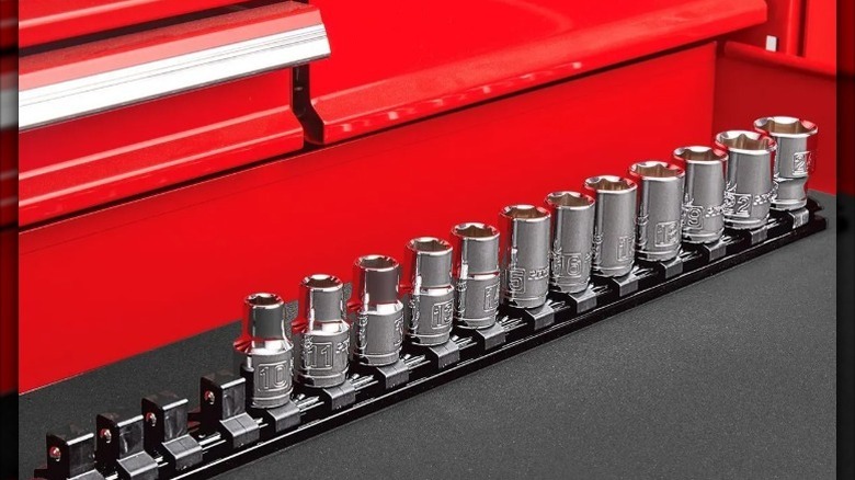 magnetic socket rail on work surface with various sockets