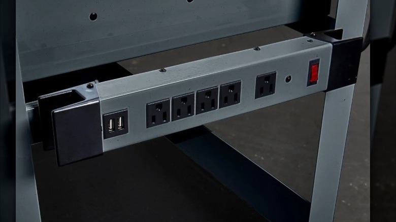 magnetic power suppy strip secured to side of workbench