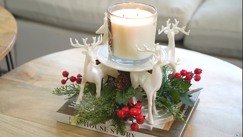 Reindeer glued to a mirror with a plate on top to create a candle holder