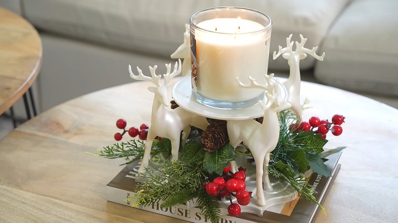 Reindeer glued to a mirror with a plate on top to create a candle holder