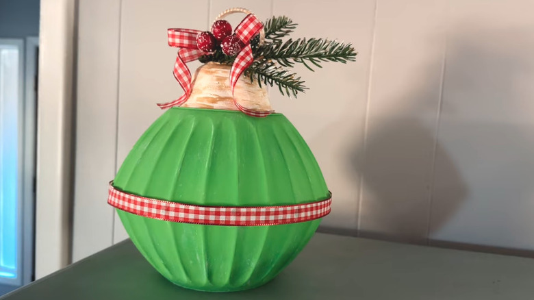 A decorative oversized Christmas ornament made from plastic bowls