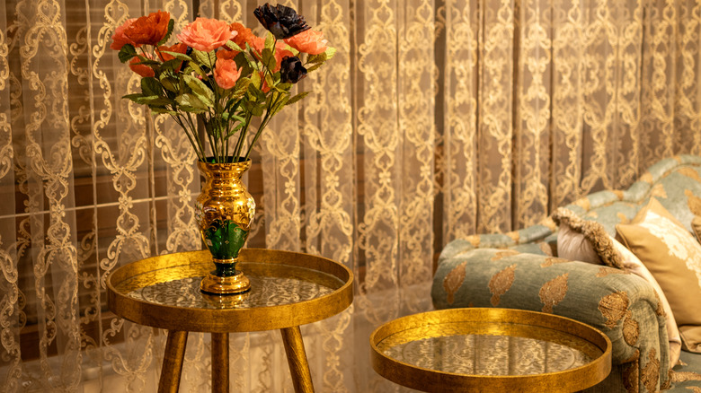 Beautiful flowers on vase on an accent table