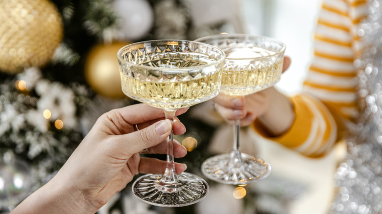 Hands toasting with crystal glasses