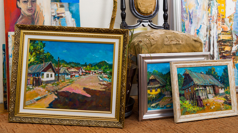 Various painting on display on the floor