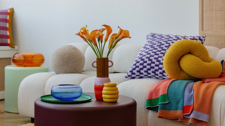Glass bowl, ceramic pottery, and vase being used as colorful accent decor